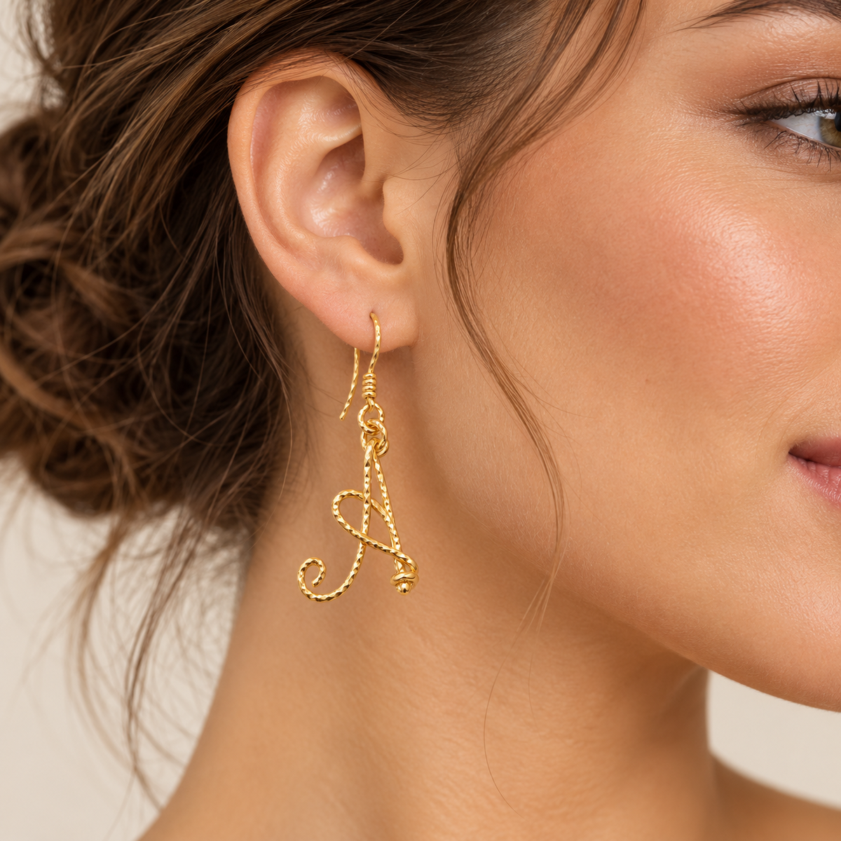 Personalized gold twisted wire initial B earring on model